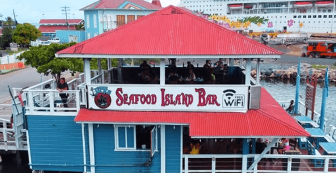 Captain Jack's over-water bar with cruise ship at the Port of Roatan