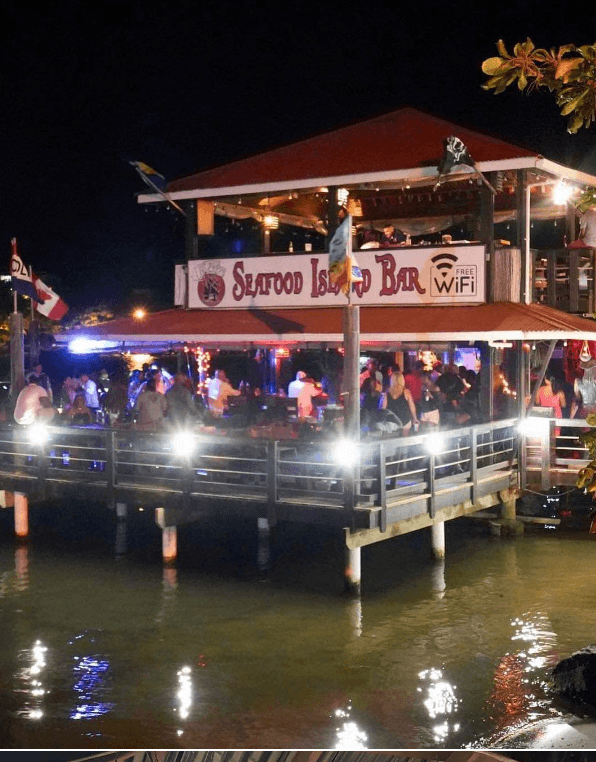 Captain Jack's bar buzzing with nightlife over the water in Roatan