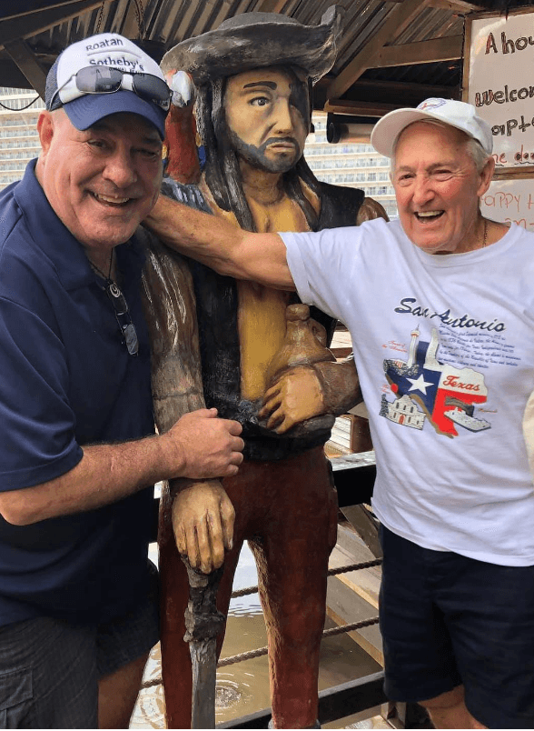 Guests posing with the Captain Jack statue at Captain Jack's Seafood Island Bar