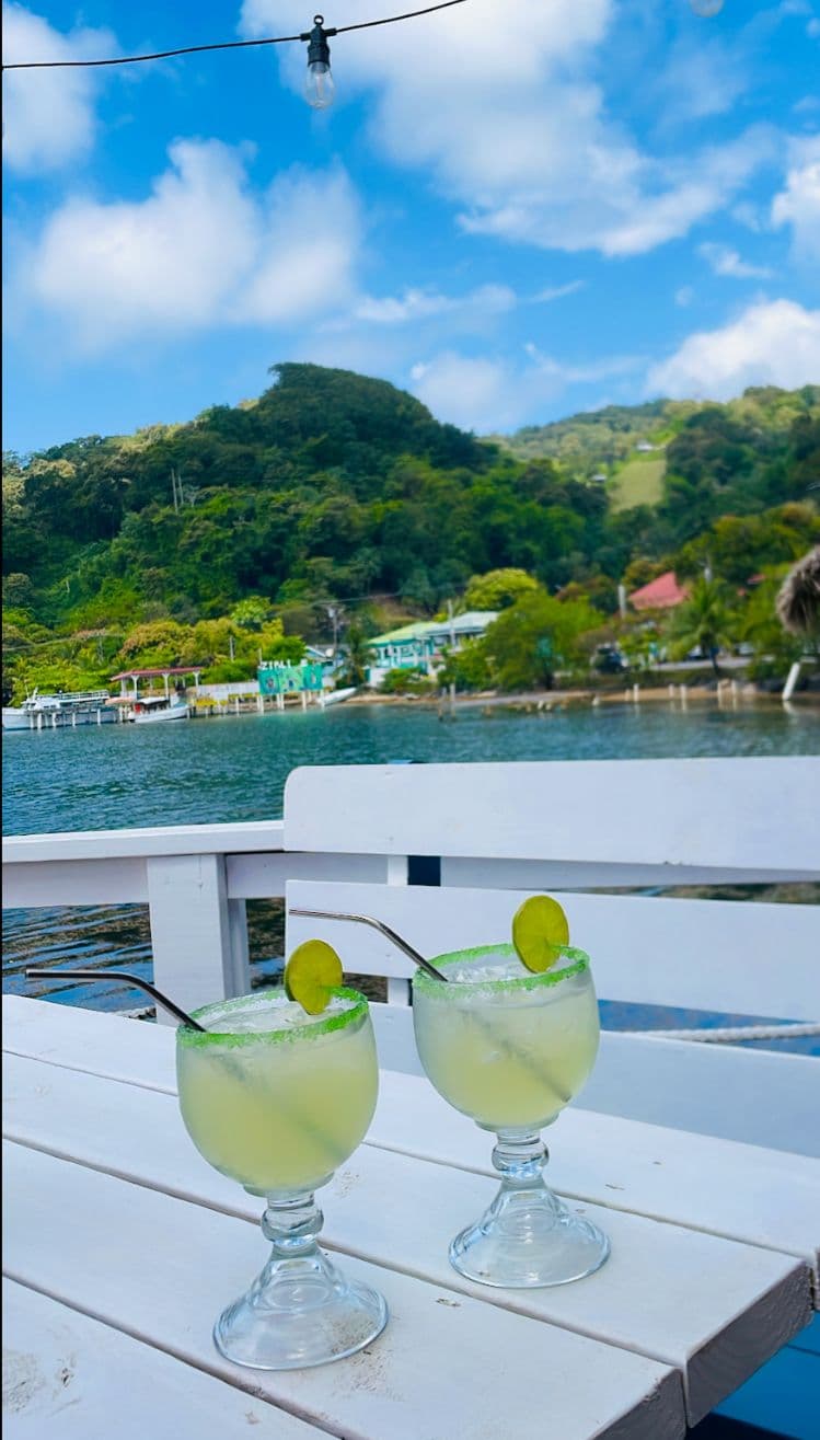 Two margaritas overlooking the turquoise Roatan bay at Captain Jack's
