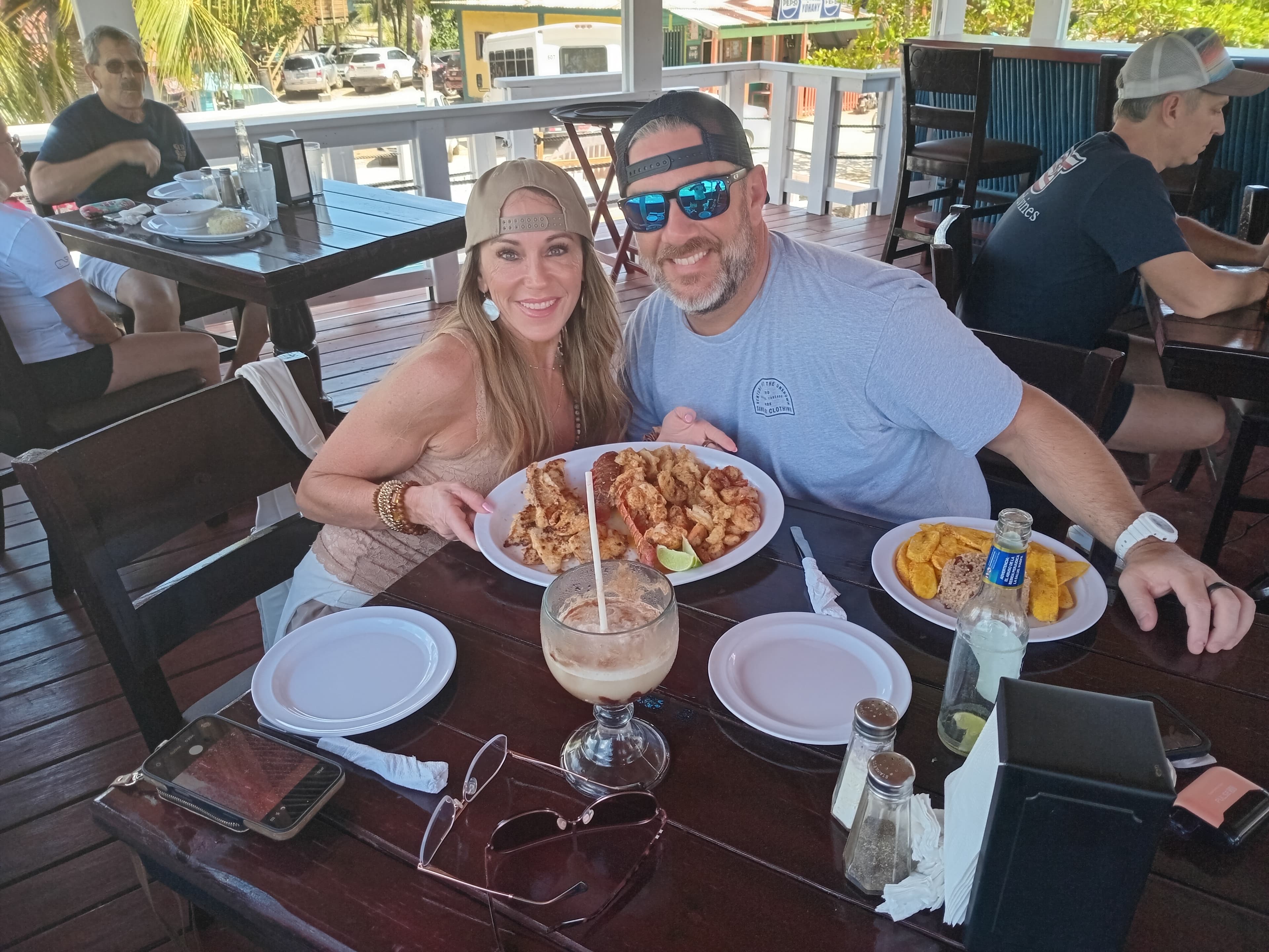 Happy guests enjoying fresh seafood and cocktails on Captain Jack's patio