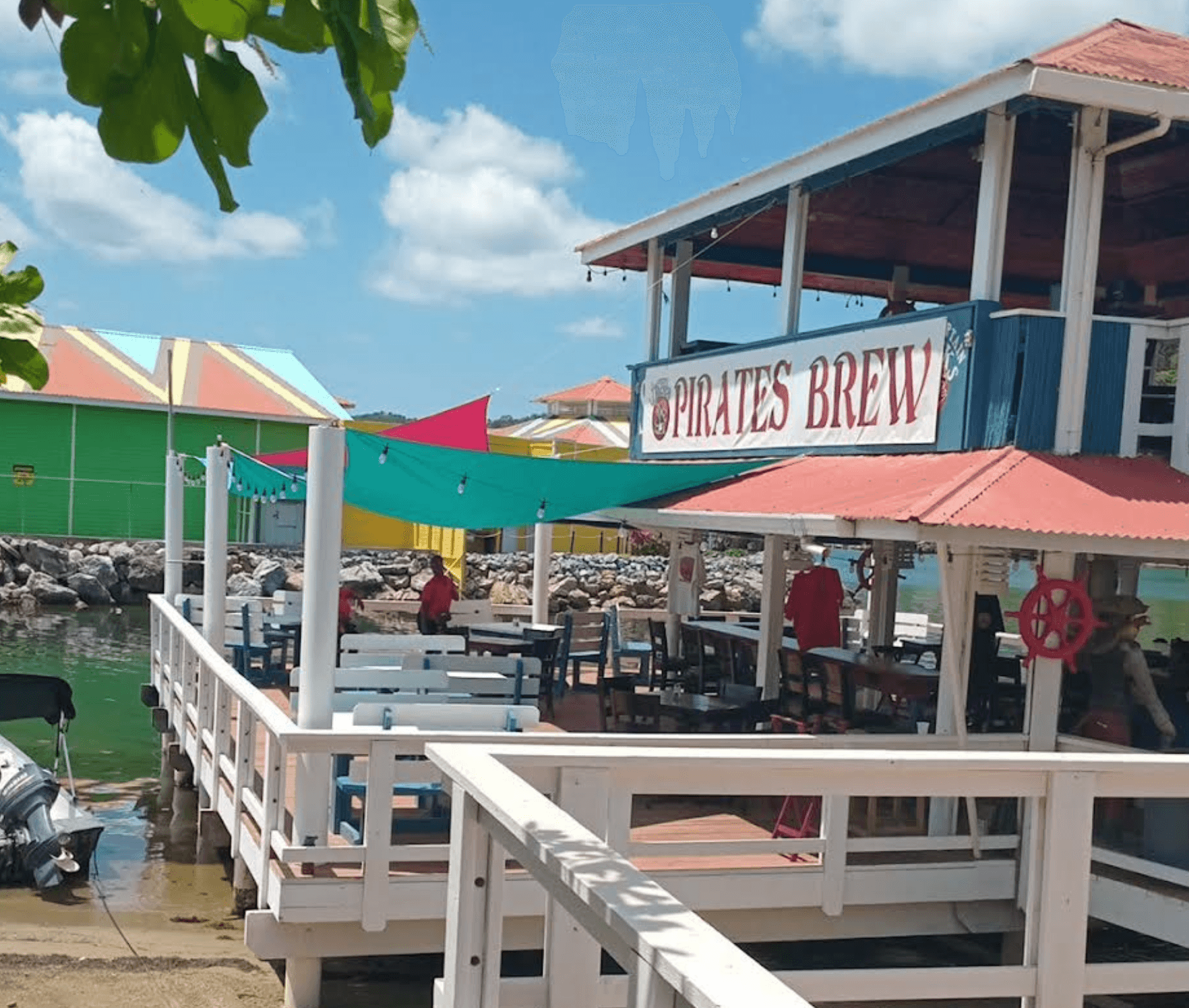 Pirates Brew sign with colorful sun sails over the water at Captain Jack's